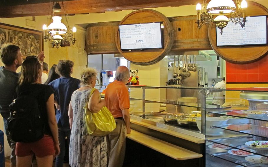 Diners at Righetti self-service restaurant in Vicenza que to select their lunch.