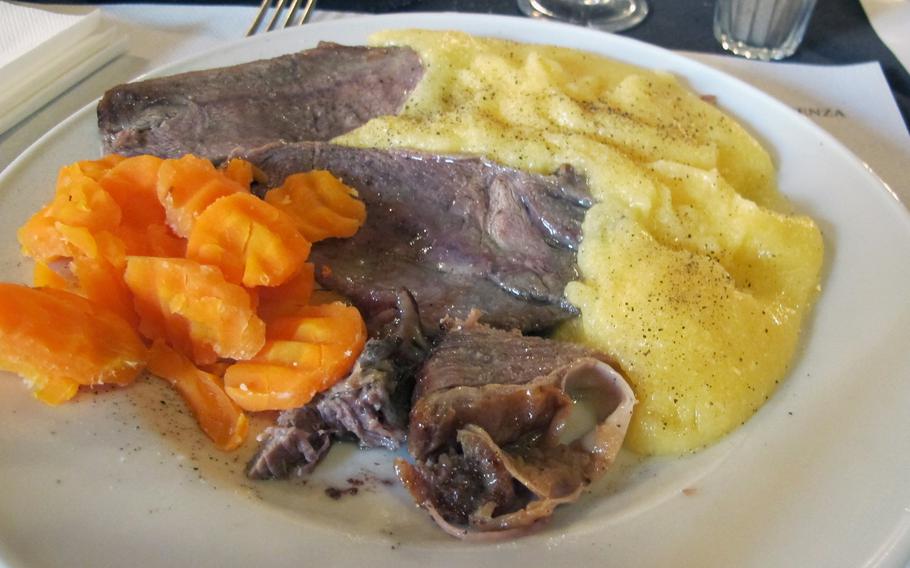 My lunch at Righetti self-service restaurant in Vicenza: roast veal, polenta and carrots, all for about 7 euros.