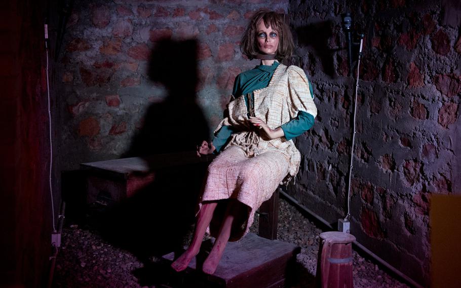 A mannequin is secured to a wooden chair with an 18th century Catalan garrote at the Medieval Torture Museum in Rudesheim am Rhein. An iron tip in the back of the device bored into the victim's cervical vertebrae and forced the neck into the metal band. It killed the victim by simultaneously destroying the spine and strangling her.