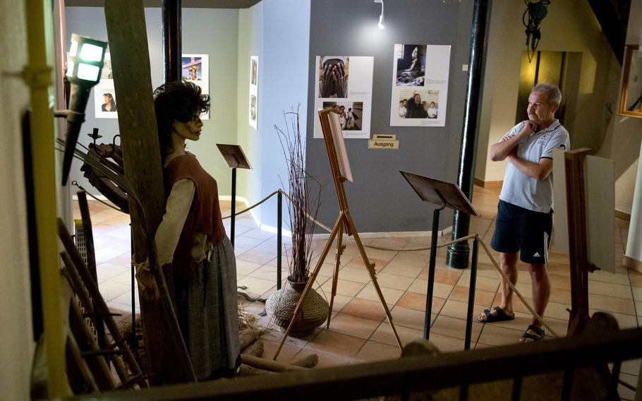 A visitor views the witch-burning display at the Medieval Torture Museum in Rudesheim am Rhein, Germany. The exhibits may be inappropriate for young children.