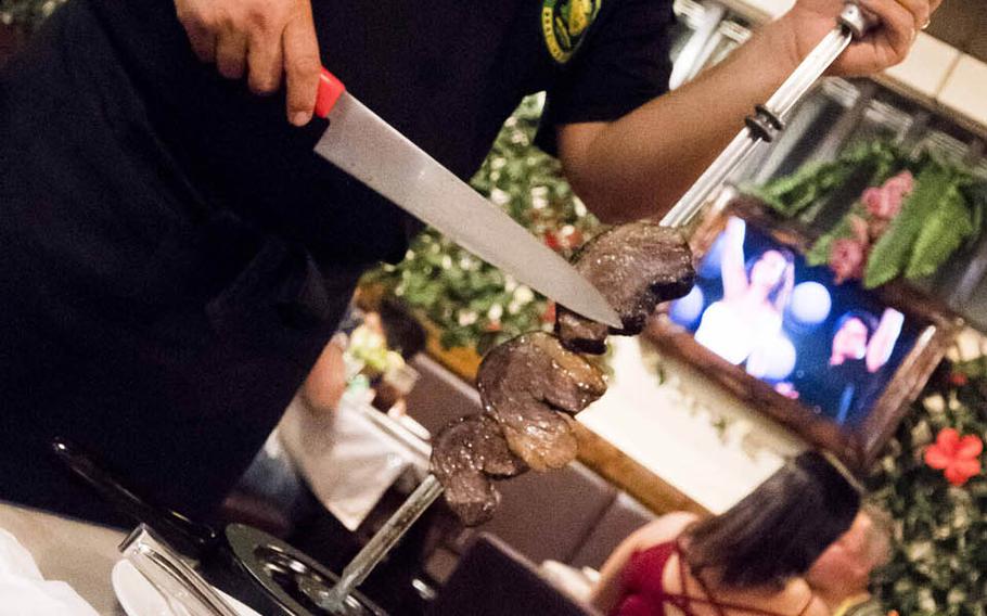 Waiters keep the meat dishes coming at Bovino's, a Brazilian steakhouse in Chatan that's been serving Okinawans for half a decade.