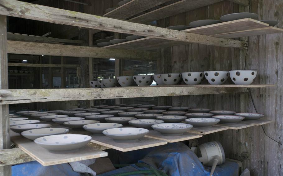 Pottery from the kiln waits to be painted and glazed at Yomitan.