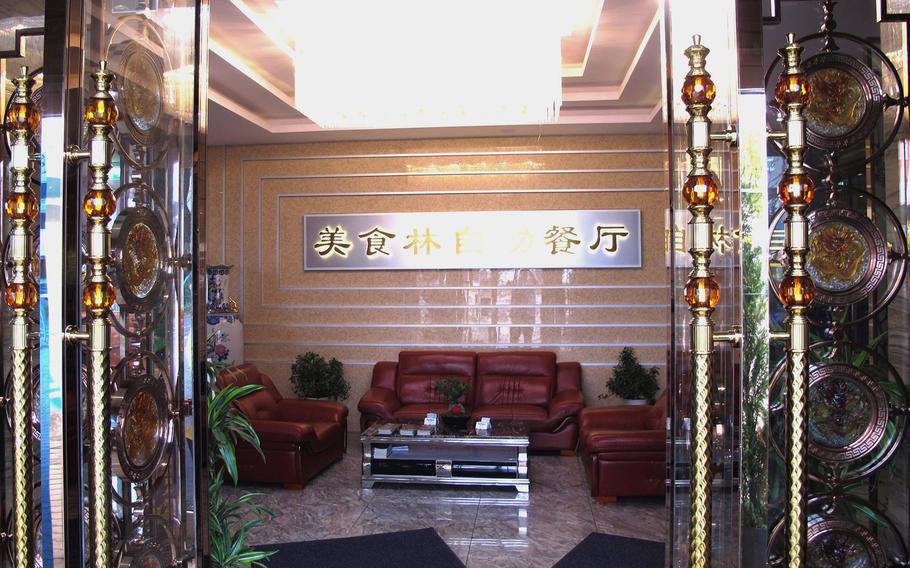 The glass and gold doors at the entrance to Gourmet Tempel welcome diners into the ornate eatery.