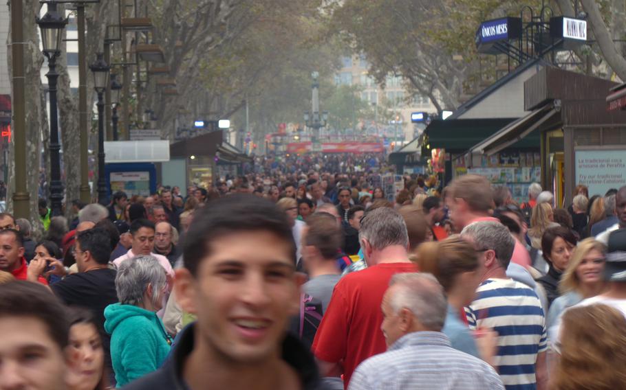 Like a human river, waves of people flow down the Las Ramblas, Barcelona's famous pedestrian area.