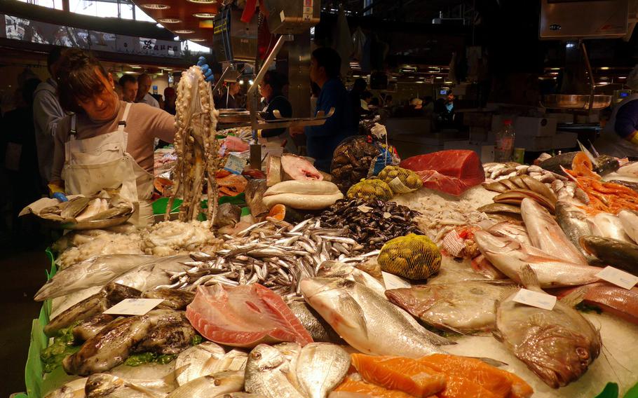 A vendor holds up an octopus at a fish and seafood stand in the Boqueria Market. If you like food, the market, just off Las Ramblas, is a site and sight in Barcelona you will not want to miss.