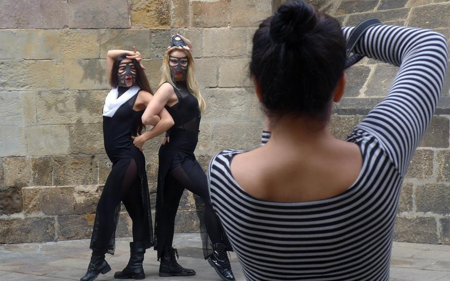 Models pose for a shoot in the Gothic section of Barcelona's old town, just off of Las Ramblas. Barcelona's pedestrian avenue and the area surrounding it have much to offer tourists in sights, food, drink and shopping.