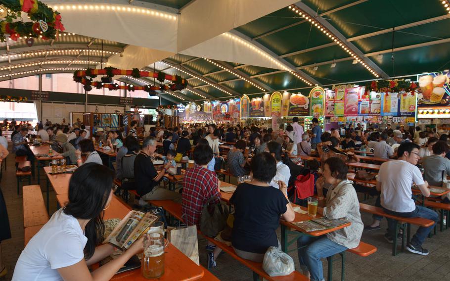 Hundreds of people enjoy German beer and food during Yokohama Oktoberfest, Tuesday, Oct. 4, 2016. The annual festival runs through Oct. 16. More than 130 types of beer are available.