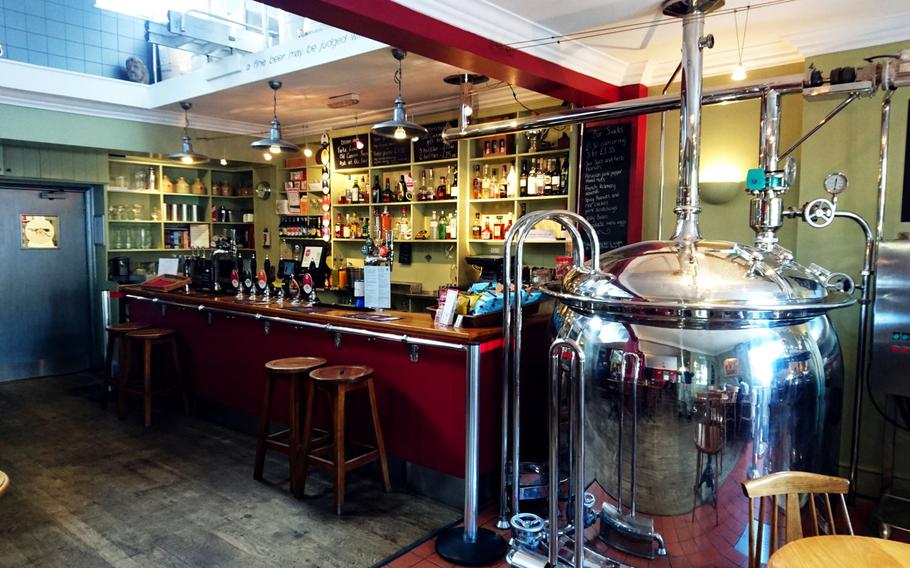 The full bar and a polished steel mash tun (a vat in which malt is mashed) and kettle at The Old Cannon Brewery. Core beers Best Bitter and Gunner's Daughter are always available, while seasonal beers, such as Hornblower or Brass Monkey are available in the spring and Gunport Stout or Black Pig in the fall and winter.