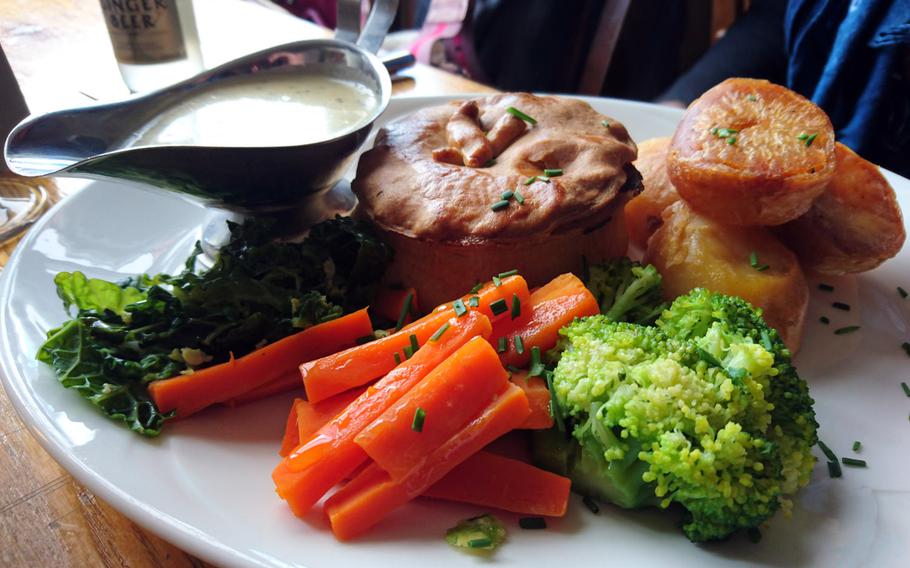 A locally sourced hand-crafted meat pie with roasted potatoes and seasonal vegetables at The Old Cannon Brewery in Bury St. Edmunds.