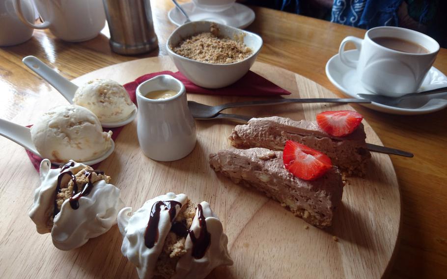 A dessert platter with taster-sized portions of toffee apple and hazelnut crumble, cheesecake, coffee and chocolate meringues and scoops of honeycomb dairy ice cream at The Old Cannon Brewery in Bury St. Edmunds, Suffolk, England.