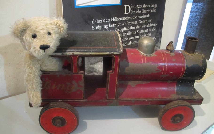 A teddy bear sits inside a Bing toy train at the Spielzeughaus Museum & Cafe in Freinsheim, Germany. The small museum opened in 2011.