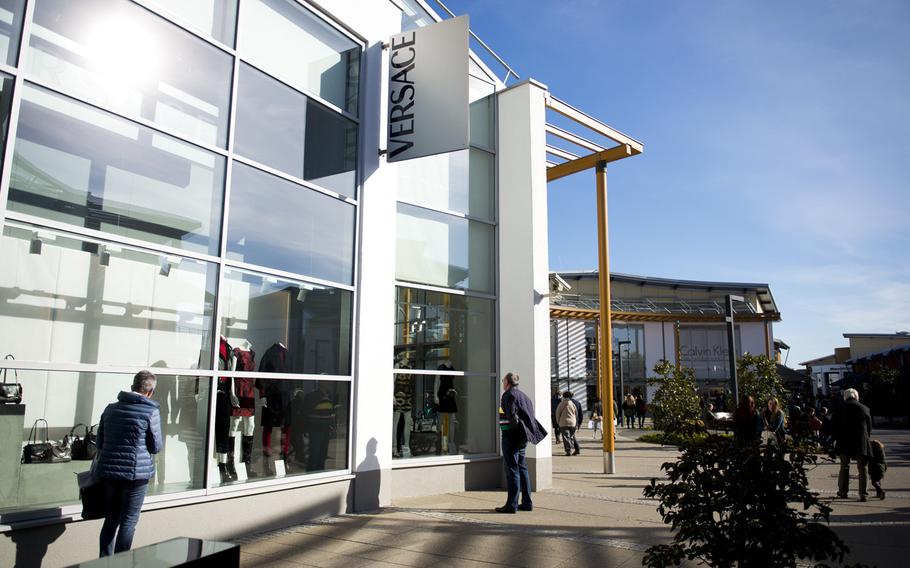 Visitors window shop at The Style Outlets in Zweibrucken, Germany, on Monday, Oct. 31, 2016. The outlet center is the largest in Germany with more than 120 stores.