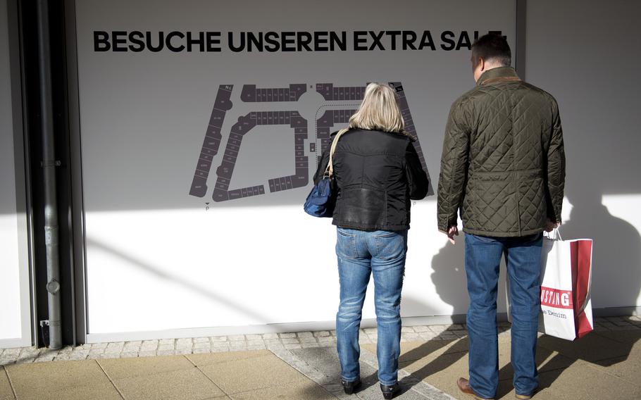 Customers plan their next move while shopping at The Style Outlets in Zweibrucken, Germany, on Monday, Oct. 31, 2016.