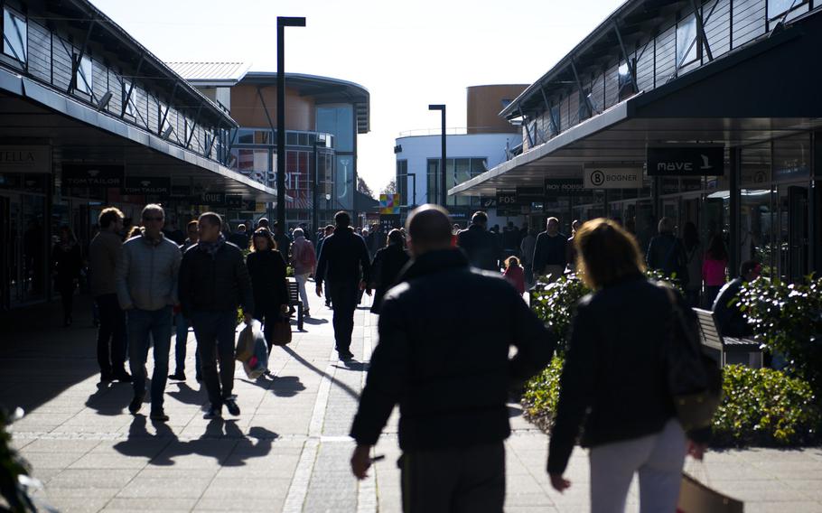 Shoppers walk down one of the thoroughfares at The Style Outlets in Zweibrucken, Germany, on Monday, Oct. 31, 2016.