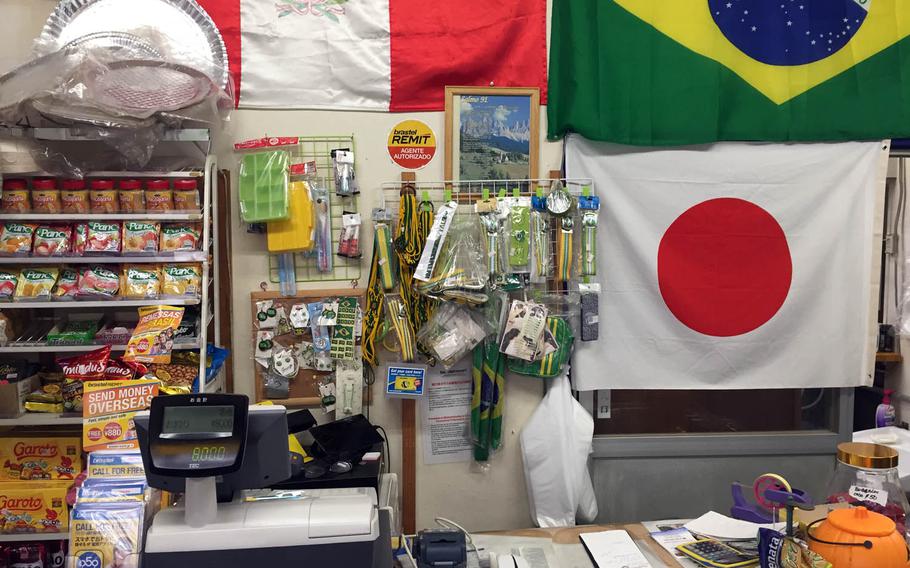 The interior of Paraiso Brasil displays both Japanese and Brazilian flags and memorabilia.