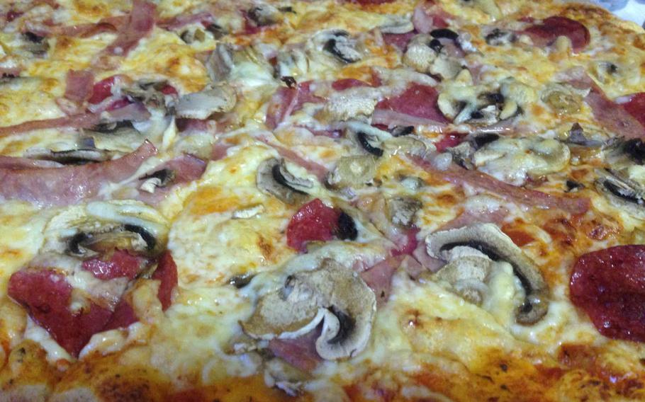 A pizza with salami, ham and mushrooms is served at Milano Ristorante & Pizzeria in Gruenstadt, Germany. The substantial, crispy crust prevent the pizza easily accommodates the generous toppings.

Gregory Broome/Stars and Stripes