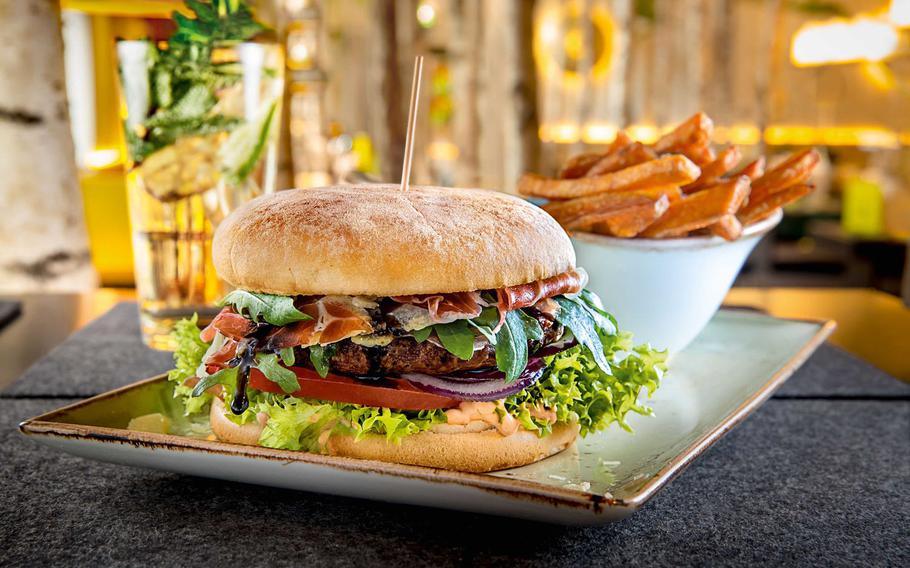 A typical burger and side of french fries at Hans im Glueck. In addition to burgers, the restaurant offers salads and a selection of vegetarian and vegan dishes. Menus are available in English.