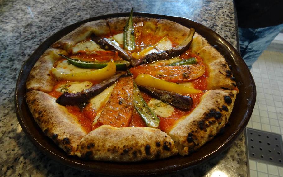 A fresh-out-of-the-oven pizza topped with locally grown vegetables from Pottery and Cafe Gunjo, a new restaurant near Zakimi Castle in Yomitan, Okinawa.