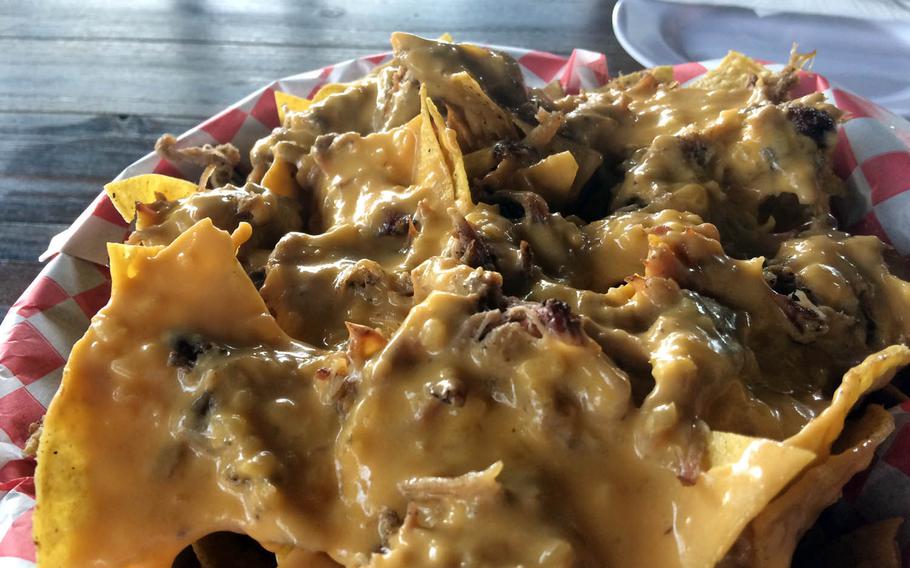 The Redneck Double-Double heaps smoky pulled pork and cheese on the nachos at Asan Sunset Grill on Guam.
