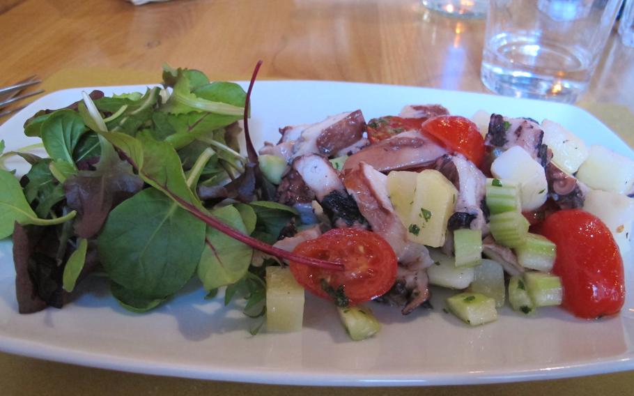 Al Ritrovo's octopus salad with cherry tomatoes, potatoes and celery arrives with a side of greens. The restaurant is an oasis in Vicenza, Italy, on Mondays, when the city is a ghost town.