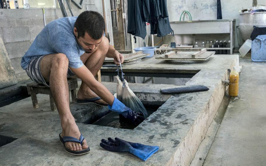 The Okinawan indigo dyeing process is slow and meticulous at Ai Kaze in Nago, Japan.