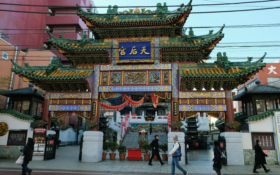 A small Chinese-style shrine sits across the street from Yokohama Daisekai in Yokohama, Japan. The best place to start your Chinatown journey is Yokohama Daisekai, an eight-story shopping plaza in the heart of the district.