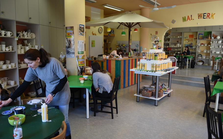 A few customers paint ceramics at Mal-Werk in Mainz, Germany, on a recent weekday morning. On weekends, the paint-your-own pottery shop and cafe is a popular venue for children's birthday parties, and reservations are suggested.