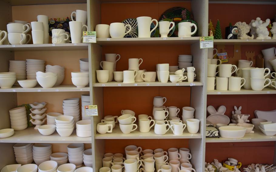 Unfinished ceramics line the shelves at Mal-Werk. Customers can pick out and paint coffee mugs, plates, bowls, piggy banks, figurines and other ceramic pieces.