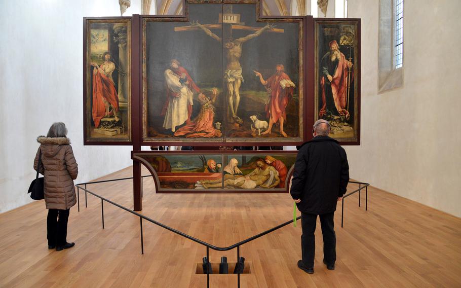 The Isenheim Altarpiece by Mathis Gruenewald is a masterpiece of 16th-century art and is the centerpiece of the Unterlinden Museum in Colmar, France. The altarpiece is displayed in three separate ensembles at the museum. This panel depicts St. Sebastian, the crucifixion, St. Anthony and the lamentation.