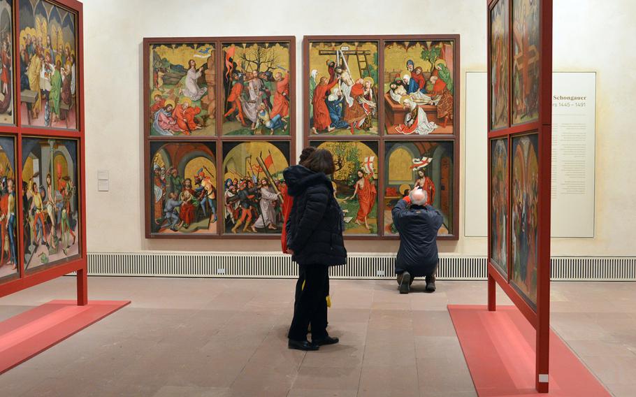 Visitors look at works by 15th-century artist Martin Schongauer at the Unterlinden Museum in Colmar, France, Jan. 19, 2017.