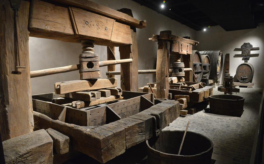 An old Alsatian wine cellar with presses and barrels is on display at the Unterlinden Museum in Colmar, France.