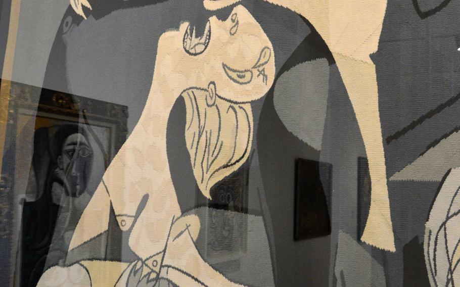 A section of tapestry by Jacqueline de La Baume, based on Pablo Picasso's "Guernica," at the Unterlinden Museum in Colmar, France. Supervised by Picasso, the artist made three copies of the work. Picasso's "Bust of a Seated Woman" is reflected in the glass at right.