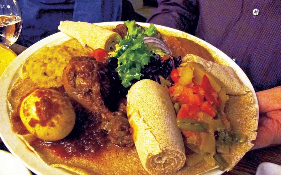 A platter for one at Safari restaurant in Kaiserslautern, Germany, included grilled lamb, a chicken drumstick, a hardboiled egg and vegetables. 