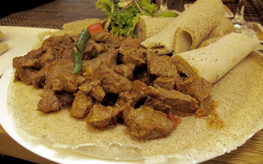 A generous portion of grilled beef or lamb is served with spongy flat bread at Safari restaurant in Kaiserslautern, Germany.

