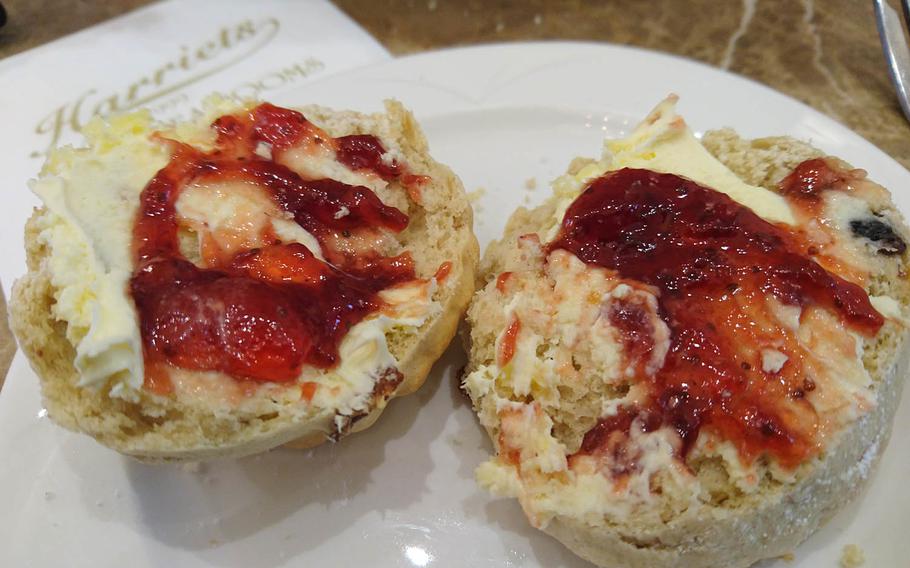 Freshly baked scones with Cornish clotted cream and strawberry jam from an order of special afternoon tea at Harriets Cafe Tearooms in Bury St. Edmunds, Suffolk, England. Afternoon tea costs 16.95-25.95 pounds per person ($21-32). 