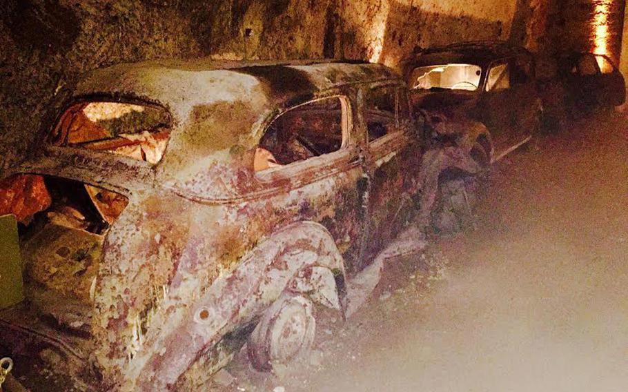 Old cars the government impounded as far back as 1950 line a stretch of the Bourbon Tunnel on March 11, 2017. They are rusty relics of a bygone era in Naples.