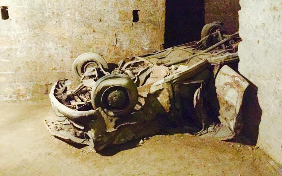 A belly-up, corroded car can be seen in the Bourbon Tunnel. The abandoned cars represent a curious chapter in the city's history, when people discarded cars the government seized.
