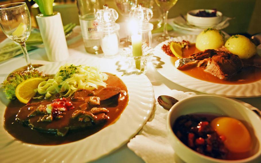 Among the dishes at Restaurant Boehm in Grafenwoehr, Germany, are venison in gravy, served with berries and peaches, and roasted duck.
