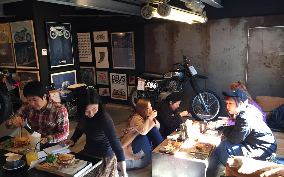 Guests can eat and drink next to the motorcycles on display at Deus Ex Machina Cafe in Tokyo.