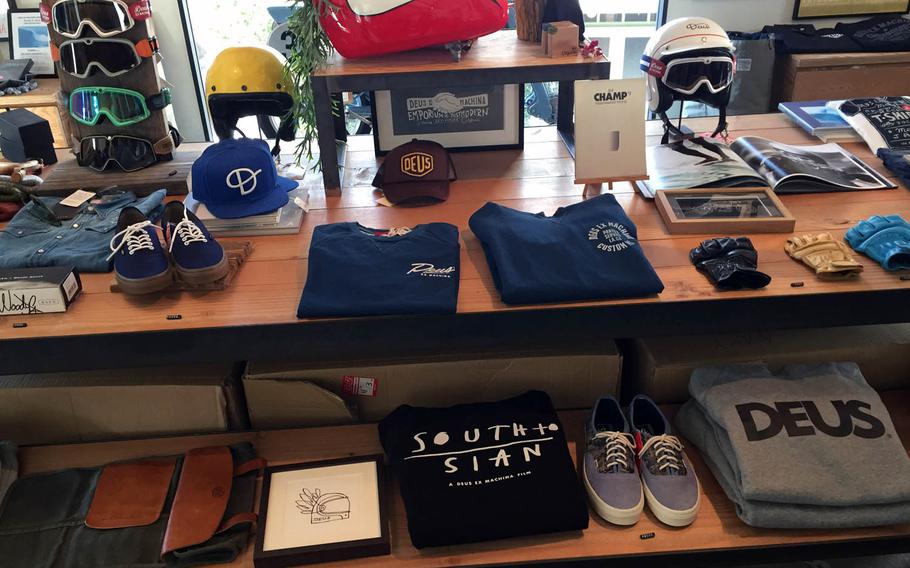 Surfing and motorcycle apparel on display at Deus Ex Machina Cafe in Tokyo.