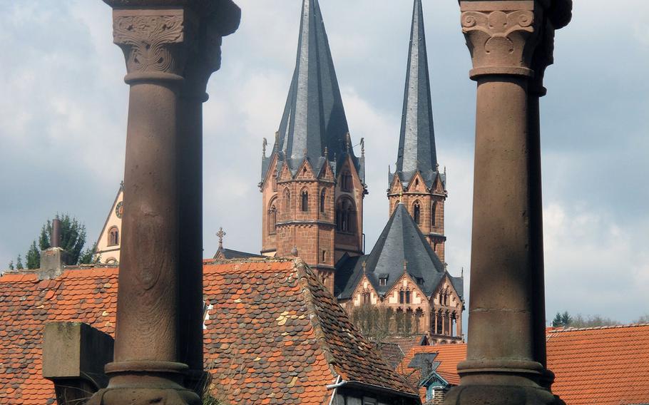 The steeples of Gelnhausen, Germany's Marienkirche are framed by the Romanesque arcades of the imperial palace