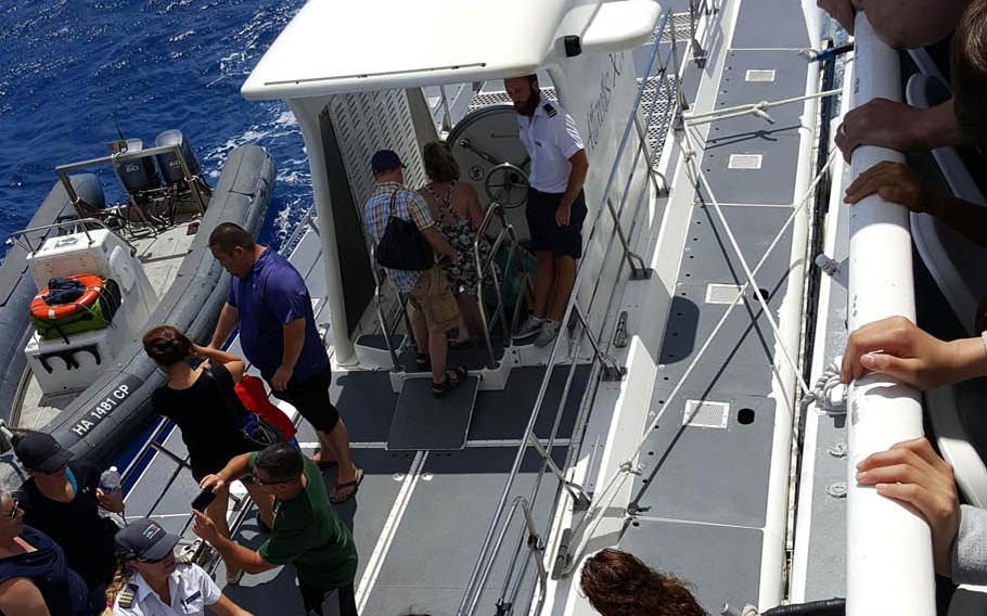Passengers transfer from a shuttle boat to an Atlantis submarine during a recent tour in Hawaii.