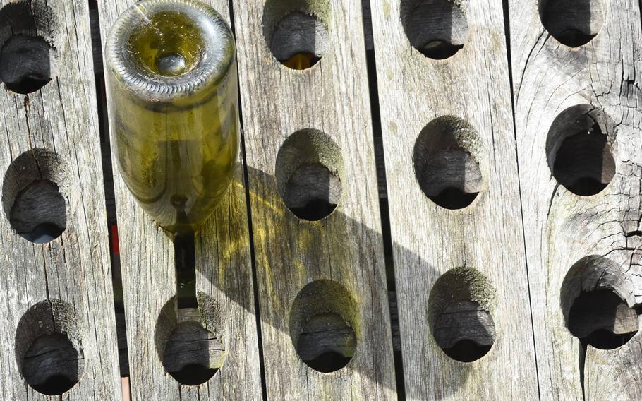 A lone wine bottle casts a shadow on a sunny day at a stop along the River Rhine Terrace Trail.