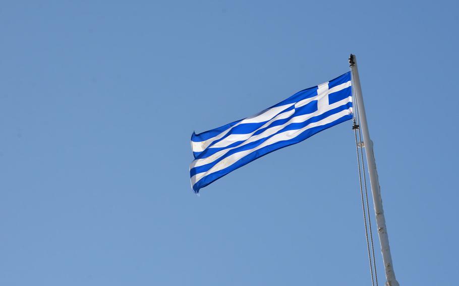 The Greek flag flies over Firka fortress that guards the entrance to Chania, Crete's Old Harbor.