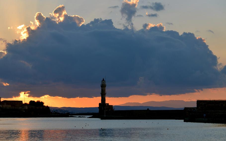 The Venetian lighthouse at the mouth of Chania, Crete's Old Port at sunset. It is sometimes called the Egyptian lighthouse because it was reconstructed by Egyptians in the 19th century.