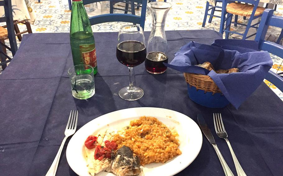 Fish and risotto served with a decanter of red house wine at Ristorante I Primi, a higher-end but popular seafood restaurant in the Posillipo neighborhood.