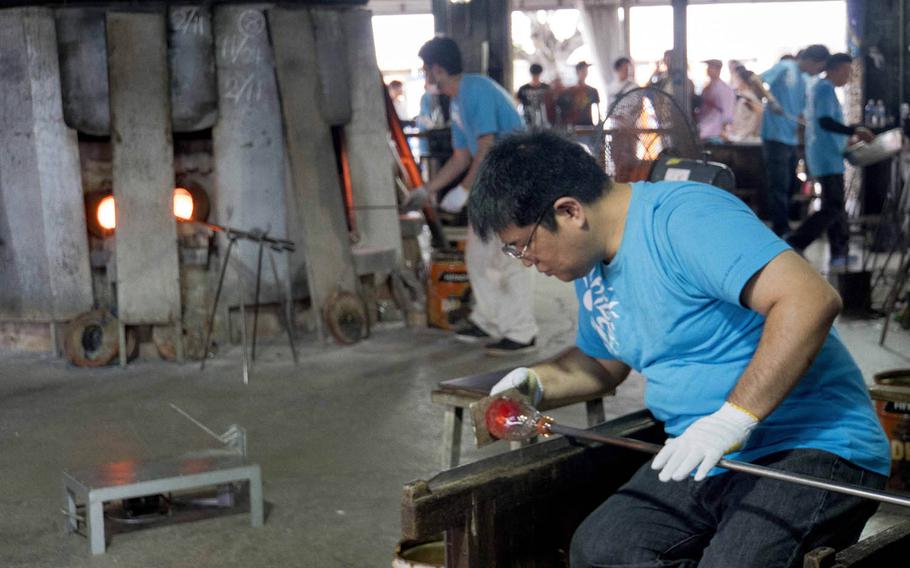 The outdoor workshop at Okinawa's Ryukyu Glass Village, next to the main building, is where all the action takes place. It can be mesmerizing to watch the artisans melt glass and form it into works of art.