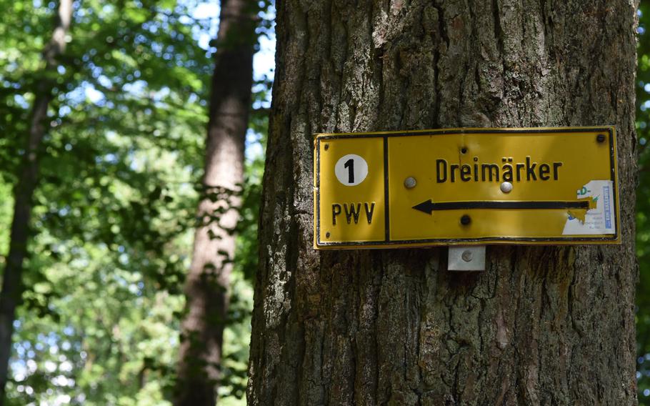 A trail marker points the way in the forested hills above Wolfstein, Germany.