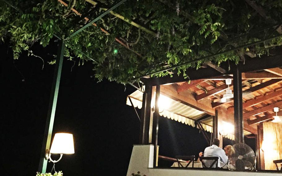 The leafy canopy and warm lamplight create a relaxing ambiance at Rosiello Ristorante in the Posillipo neighborhood of Naples, Italy. 

Scott Wyland/Stars and Stripes