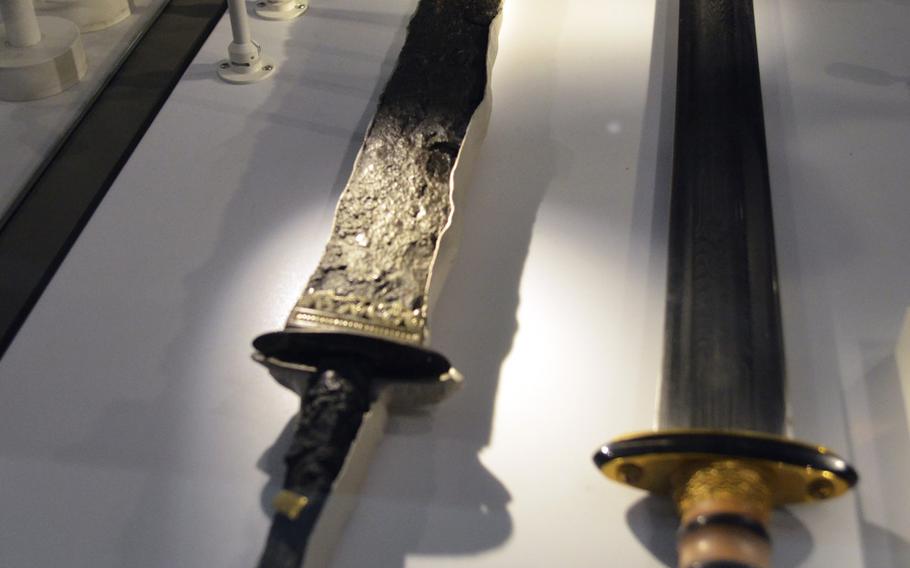 A display with a modern replica of an Anglo-Saxon sword alongside an original one dating to the late fifth-early sixth century at the Birmingham Museum and Art Gallery in Birmingham, England. Swords were rare in Anglo-Saxon England; only the nobility or the king's guard had swords with gold and silver handles.